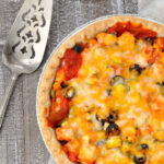 Overhead photo of Mexican leftover turkey pie with serving utensil to upper left