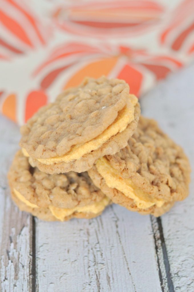 The most delicious oatmeal cookie ever filled with pumpkin cream cheese frosting. Absolutely the best fall cookie ever!