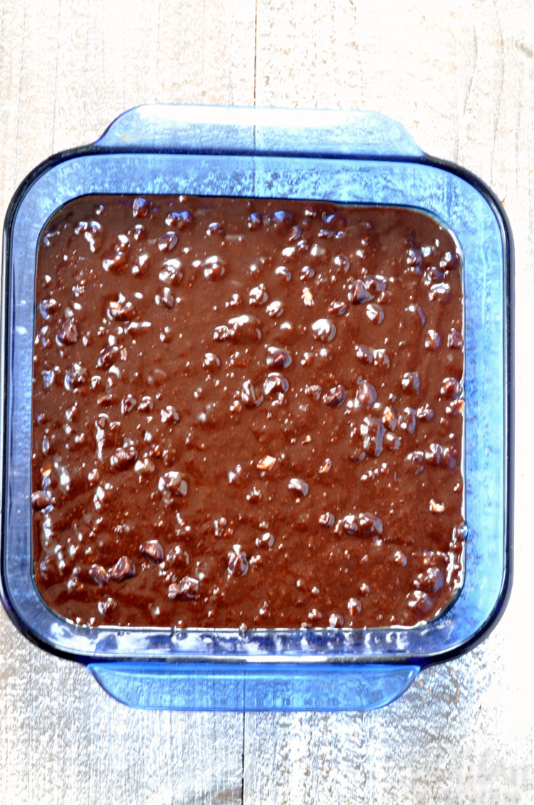 brownie batter in blue baking dish