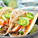 Front looking view of Vietnamese pork banh mi tacos on plate