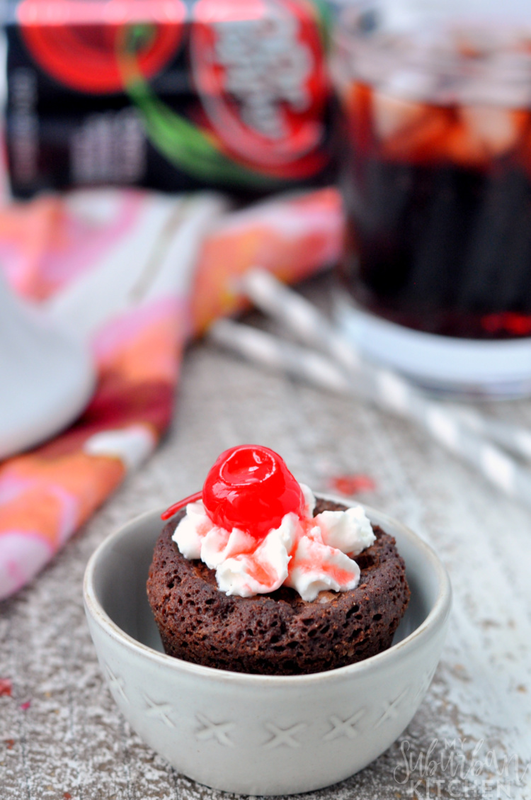 Up close photo of Cherry Dr Pepper brownie bite in bowl with soda in background
