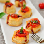 Mini Caprese Appetizer on white serving plate with fork