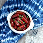 BBQ Little Smokies Crockpot in white bowl sitting on blue napkin
