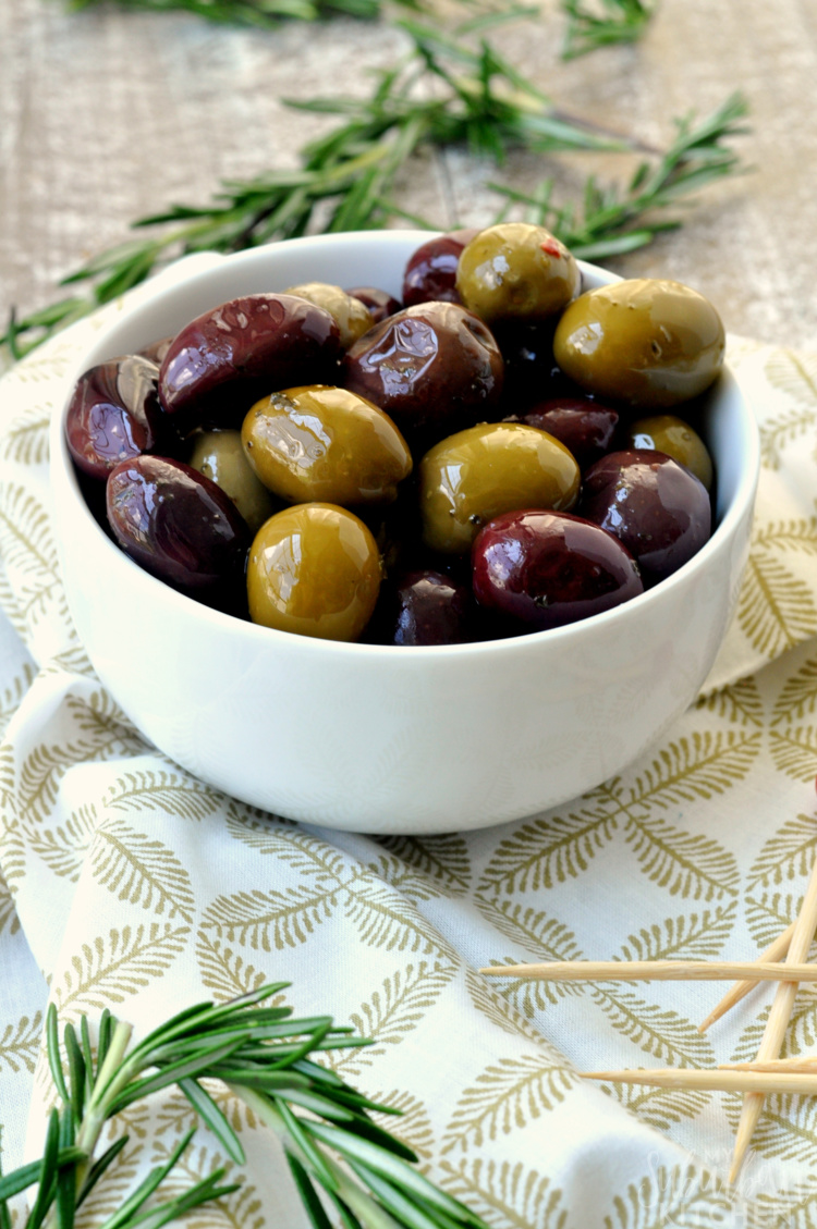 White bowl of marinated mixed olives